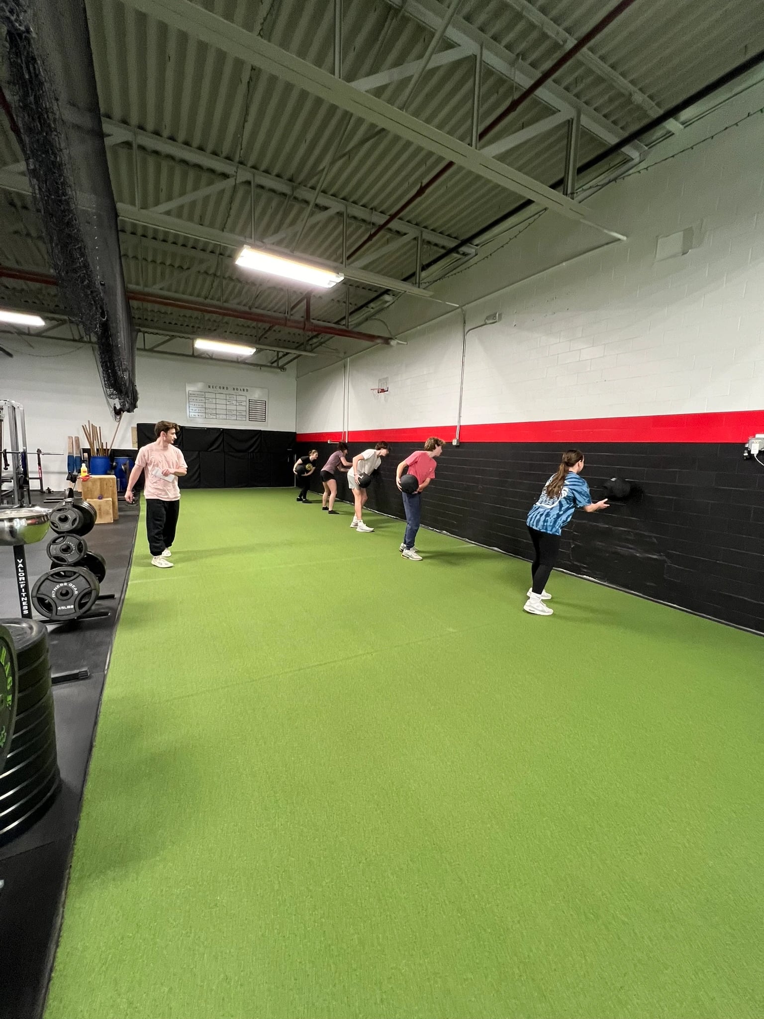 Nick coaching a group of athletes on the turf