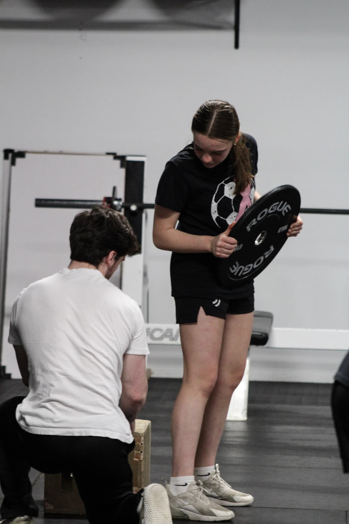 Nick coaching an athlete through a strength exercise