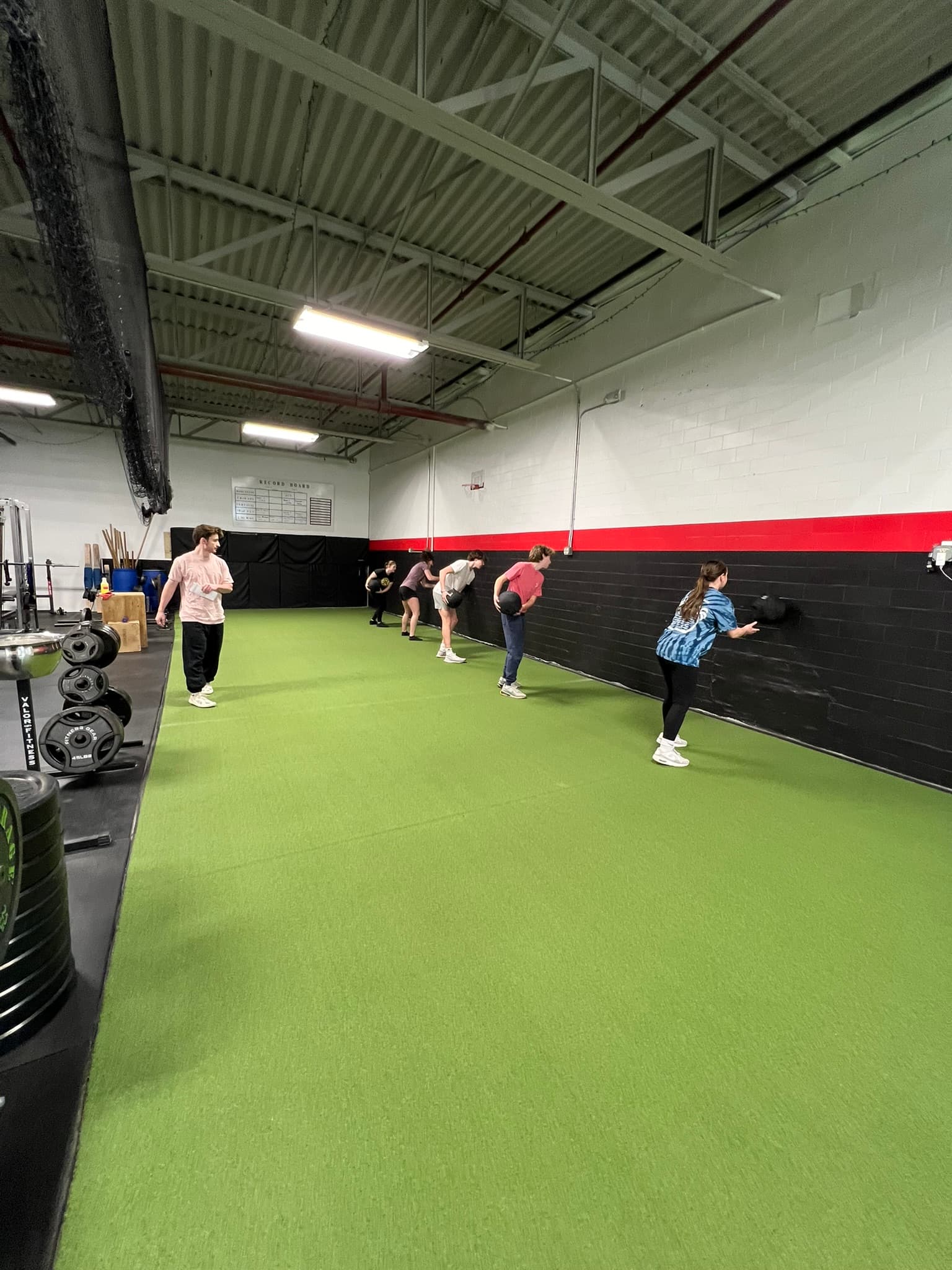 Nick coaching a group of athletes on the turf